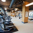 Gym Room Dwellatvue Appealing Gym Room In The Dwellatvue Apartment With Brown Pillars And Wide Glass Windows Under Grey Ceiling Decoration Amazing Elegant Dwelling For Fantastic Modern Home Tour