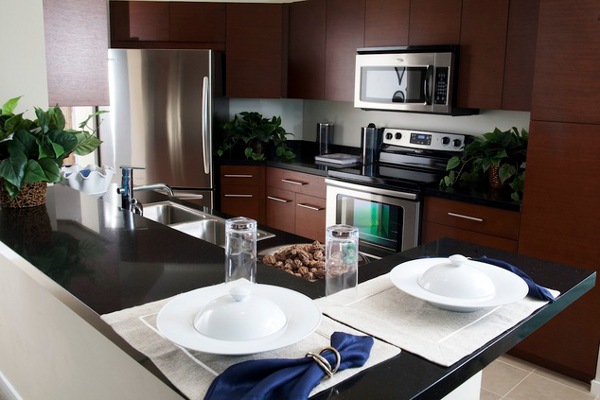 Dwellatvue Apartment Wooden Attractive Dwellatvue Apartment Kitchen With Wooden Drawers And White Backsplash Near White Island And Dark Countertop Decoration  Amazing Elegant Dwelling For Fantastic Modern Home Tour