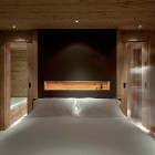 Chalet Gstaad Architectes Bright Chalet Gstaad Amaldi Neder Architectes Master Bedroom Recessed Lamps And LED Light Inside Shelf Decoration Eclectic White Chalet Decoration With Wooden Veneer For Walls