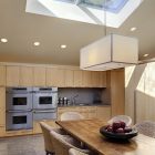 Kitchen Design Kitchen Charming Kitchen Design With Wooden Kitchen Table And Rattan Chairs At Glencoe Residence Lightened By Skylight Window Kitchens Lovely Steel Kitchen With Photo Frames And Flower Decorations