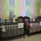 Striped Patterned Where Cheerful Striped Patterned Center Wall Where Black Mini Cribs For Twins Located With Nickname Board As Arts Kids Room Minimalist Mini Cribs In Various Room Designs