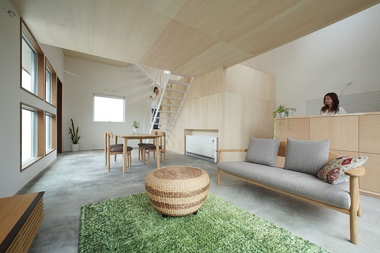 Living Room House Cozy Living Room In Azuchi House Sumiou Mizumoto With Rattan Coffee Table On Green Carpet Area And Grey Sofa Decoration Outstanding Single Family House In Minimalist Wooden Decoration