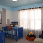 Catching City On Eye Catching City Mural Studded On Center Wall Of Nursery Interior With Blue Cribs And Colorful Crib Sheet Kids Room Astonishing Crib Sheet For Baby In Small Minimalist Room