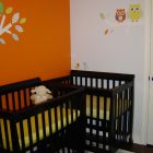 Catching Orange Wall Eye Catching Orange Painted Center Wall Set As Mini Cribs Background Combined With Yellow Accent On Mattress Kids Room Minimalist Mini Cribs In Various Room Designs