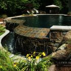 Stone Details Interesting Fabulous Stone Details In The Interesting Pool Another Fine Project By Lewis Aquatech Beside Grass Yard Dream Homes Magnificent Outdoor Swimming Pool With Sensational Backyard And Patio
