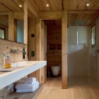 Chalet Gstaad Architectes Minimalist Chalet Gstaad Amaldi Neder Architectes Master Bath With Hidden Toilet And Shower With Glass Decoration Eclectic White Chalet Decoration With Wooden Veneer For Walls