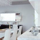 Crystal Chandelier Light Stunning Crystal Chandelier And LED Light Rectangular Dining Table White Chairs Dark Sideboard Rectangular Mirror Shiny Kitchen Backsplash Light Living Room Luxury Living Room In Elegant Contemporary Style