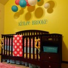 Yellow Painted Ideas Surprising Yellow Painted Nursery Decor Ideas With Turquoise Name On Center Wall Above Black Painted Crib With Storage Decoration Lovely Nursery Decor Ideas With Secured Bedroom Appliances