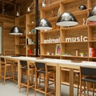 Details In Shelves Wonderful Details In The Wooden Shelves Near Animal Music Studio Sitting Area With Wooden Stools And Wooden Table Decoration Trendy And Fascinating Office Design Of The Animal Music Project