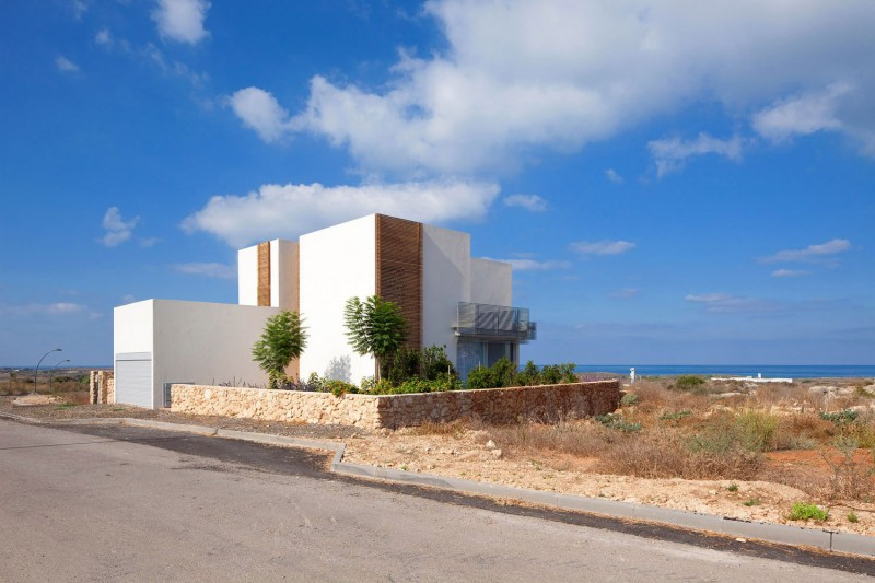 House A Land Amazing House A Involved Dry Land With Dry Plants Surrounded It And Stone Patterned Fence Around It With Blue Atmosphere Decoration  Surprising Home Decoration With An Open Landscape Of Seaside Views