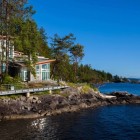 Pender Harbour Asymmetric Amazing Pender Harbour House With Asymmetric Roof And Glass Wall Shady Greenery Long Bridge With Metallic Railing Architecture Stunning Waterfront House With Lush Forest Landscape