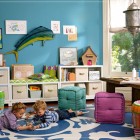 Kids Playroom Shelving Attractive Kids Playroom With White Shelving Units And Colorful Tufted Stools On White Blue Carpet With Rattan Basket Kids Room Cheerful Kid Playroom With Various Themes And Colorful Design