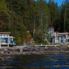 Pender Harbour Geometric Attractive Pender Harbour House With Geometric Sloping Roof Transparent Glass Wall Long Bridge With Tough Metallic Railing Long River And Shady Greenery Architecture Stunning Waterfront House With Lush Forest Landscape