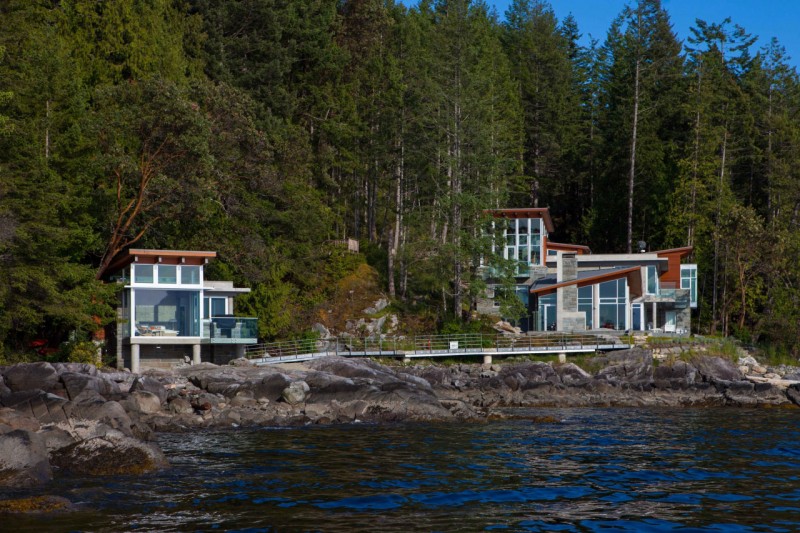 Pender Harbour Geometric Attractive Pender Harbour House With Geometric Sloping Roof Transparent Glass Wall Long Bridge With Tough Metallic Railing Long River And Shady Greenery Architecture Stunning Waterfront House With Lush Forest Landscape