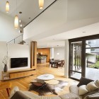 Living Room Leather Awesome Living Room With Curved Leather Sofa And Oval Coffee Table Sophisticated TV Wood Sideboard Tube Pendant Lights Quarry Street House Marina Rubina Decoration Stylish Contemporary Prefab House With Industrial Wooden Furniture