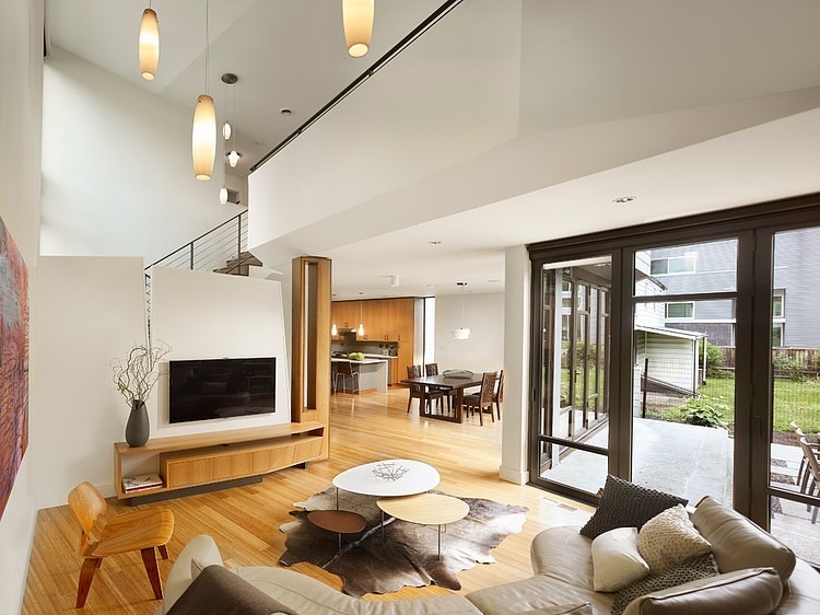 Living Room Leather Awesome Living Room With Curved Leather Sofa And Oval Coffee Table Sophisticated TV Wood Sideboard Tube Pendant Lights Quarry Street House Marina Rubina Decoration  Stylish Contemporary Prefab House With Industrial Wooden Furniture