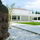 Statue Placed Yard Buddha Statue Placed On Front Yard Of Sleek White Contemporary Villa In Madrid As Welcoming Exterior Apartments Sophisticated Scandinavian Living Rooms As Inspirational Design For You