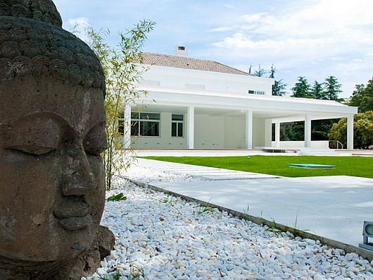 Statue Placed Yard Buddha Statue Placed On Front Yard Of Sleek White Contemporary Villa In Madrid As Welcoming Exterior Apartments Sophisticated Scandinavian Living Rooms As Inspirational Design For You