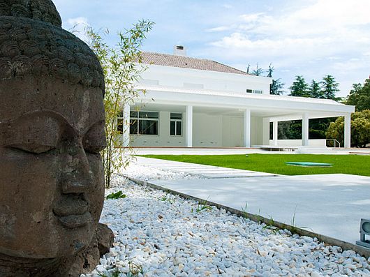 Statue Placed Yard Buddha Statue Placed On Front Yard Of Sleek White Contemporary Villa In Madrid As Welcoming Exterior Apartments  Sophisticated Scandinavian Living Rooms As Inspirational Design For You