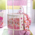 Baby Girl Crib Chic Baby Girl Themed Round Crib With Colorful Flowers Attached As Pattern Over The Mattress And Blanket Kids Room Adorable Round Crib Decorated By Vintage Ornaments In Small Room