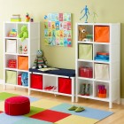 Cube Storage Colors Cute Cube Storage In Primary Colors Child's Playroom With Dolls And Toys Installed On It Involved Colorful Tiled Carpet Kids Room Cheerful Kid Playroom With Various Themes And Colorful Design
