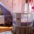 White Round Completed Cute White Round Crib Idea Completed With Purple Mattress And Metallic Skirt With Net And Pink Ribbon On Posts Kids Room Adorable Round Crib Decorated By Vintage Ornaments In Small Room