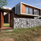 Modern Flair In Eclectic Modern Flair W House In Compact Shape With Rustic Stone Wall Solid Wood Door With Stainless Steel Knob Architecture Elegant Concrete Home With Spacious And Modern Style In Thailand