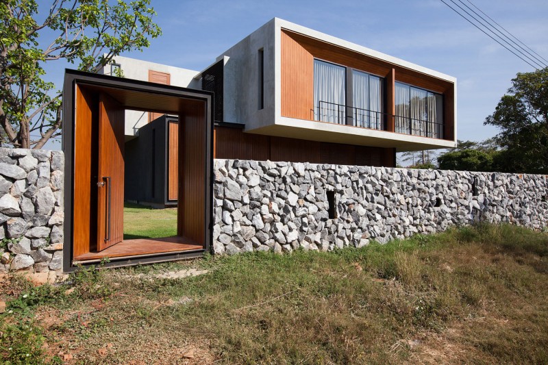 Modern Flair In Eclectic Modern Flair W House In Compact Shape With Rustic Stone Wall Solid Wood Door With Stainless Steel Knob Architecture Elegant Concrete Home With Spacious And Modern Style In Thailand