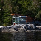 Shady Greenery Rocks Enchanting Shady Greenery And Huge Rocks Near Large River Transparent Glass Wall Long Bridge With Metallic Railing Architecture Stunning Waterfront House With Lush Forest Landscape