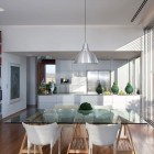 Layout Between Shelves Exciting Layout Between Wooden Books Shelves Kitchen And Glass Dining Desk With White Single Chairs In Artistic Clutter House Decoration Surprising Home Decoration With An Open Landscape Of Seaside Views