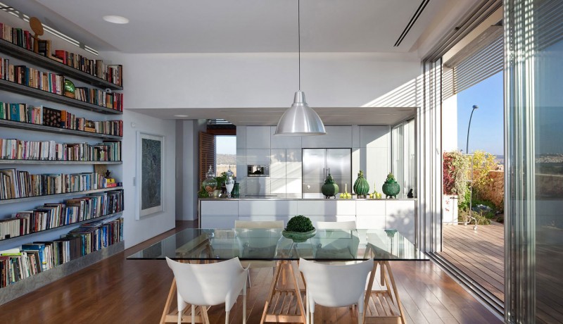 Layout Between Shelves Exciting Layout Between Wooden Books Shelves Kitchen And Glass Dining Desk With White Single Chairs In Artistic Clutter House Decoration Surprising Home Decoration With An Open Landscape Of Seaside Views