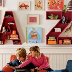 Quirky Alphabet Childs Exciting Quirky Alphabet Storage Units Child's White Playroom Using Red Colored Shelves On White Painted Wall With Mural Kids Room Cheerful Kid Playroom With Various Themes And Colorful Design
