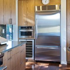 Catching Stainless Such Eye Catching Stainless Steel Appliances Such As Fridge Placed Between Wooden Cabinets In Breeze House Kitchen Architecture Elegant Spacious Home With Wooden Material And Bright Interior Themes