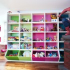 Themed White Childsroom Feminine Themed White Attic Style Child's Room With Pink And Green Storage Cubes And Spider Man On Wooden Floor Kids Room Cheerful Kid Playroom With Various Themes And Colorful Design