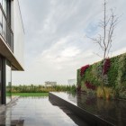 Terrace Area And Glossy Terrace Area With Planters And Reed Covered The Wall In The Valna House That Green Yard Completed The Decor Dream Homes Swanky Modern House Design For Elegant Dwelling Place