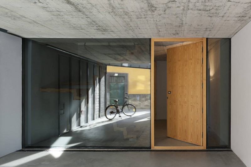 Wooden Door Glass Interesting Wooden Door Design With Glass Wall In Outeiro House Showing Bicycle Which Standing Alone Dream Homes Comfortable And Elegant House In Brown And White Color Schemes