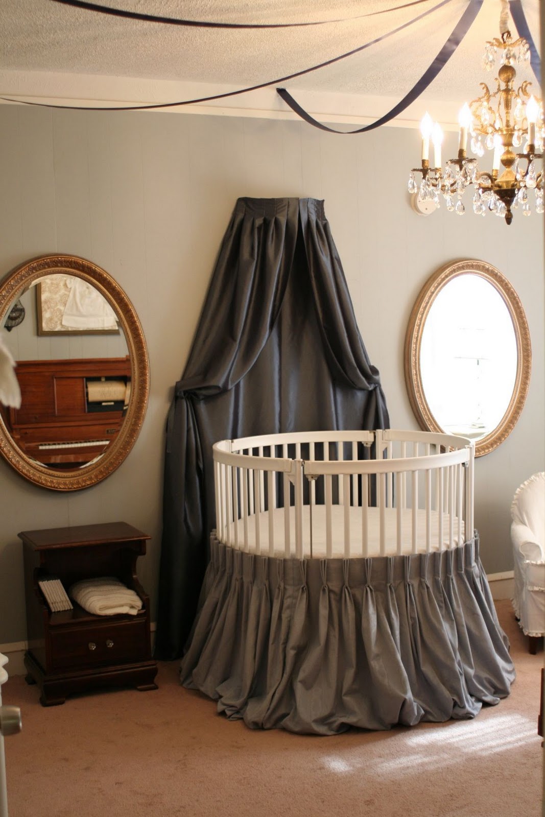 Dark Grey Installed Luxurious Dark Grey Canopy Curtain Installed On Wall To Match Round Crib With Grey Skirt Covering The Legs Kids Room Adorable Round Crib Decorated By Vintage Ornaments In Small Room