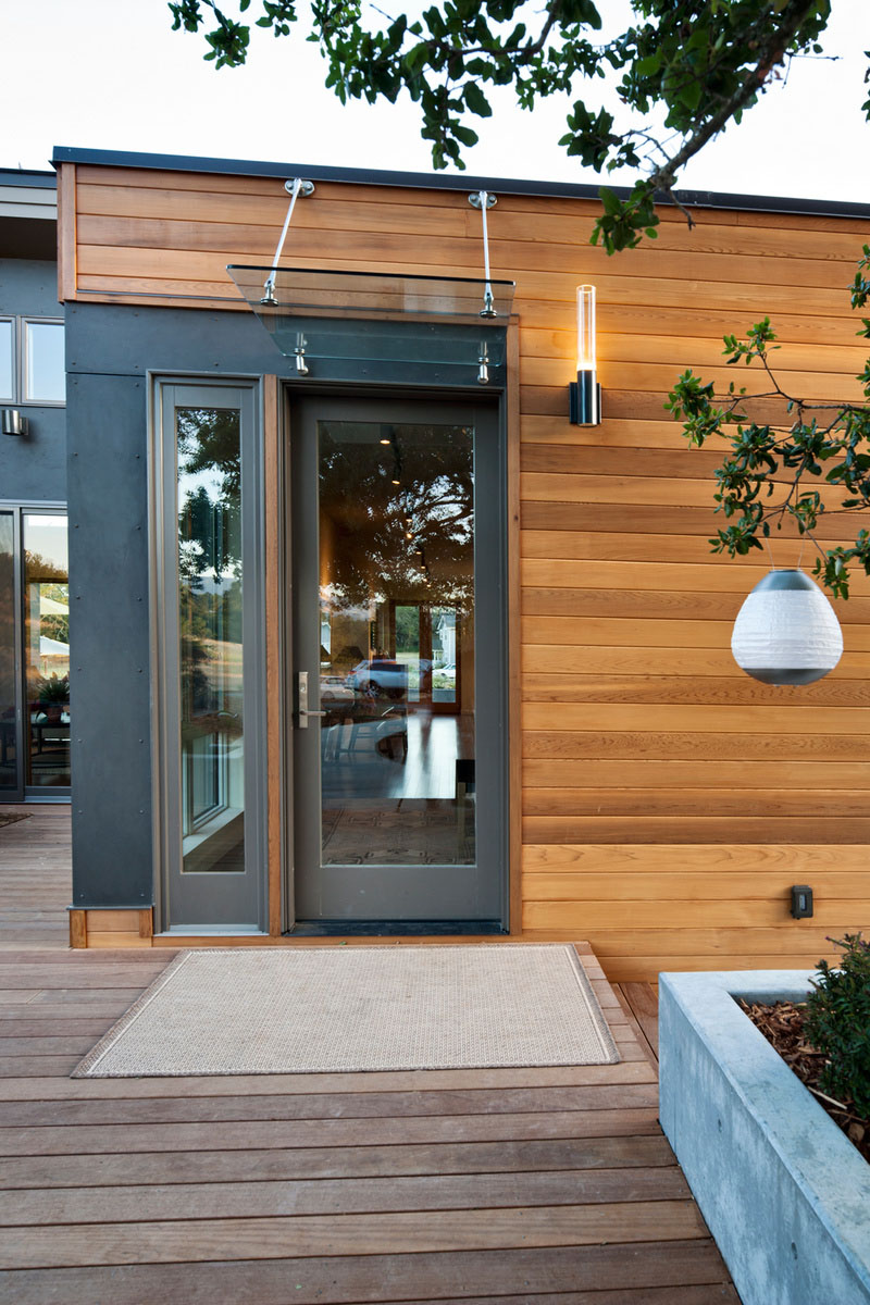 Breeze House Displaying Minimalist Breeze House Entrance Idea Displaying Dark Grey Painted Glass Door And Window To Hit Wood Abundance Architecture  Elegant Spacious Home With Wooden Material And Bright Interior Themes