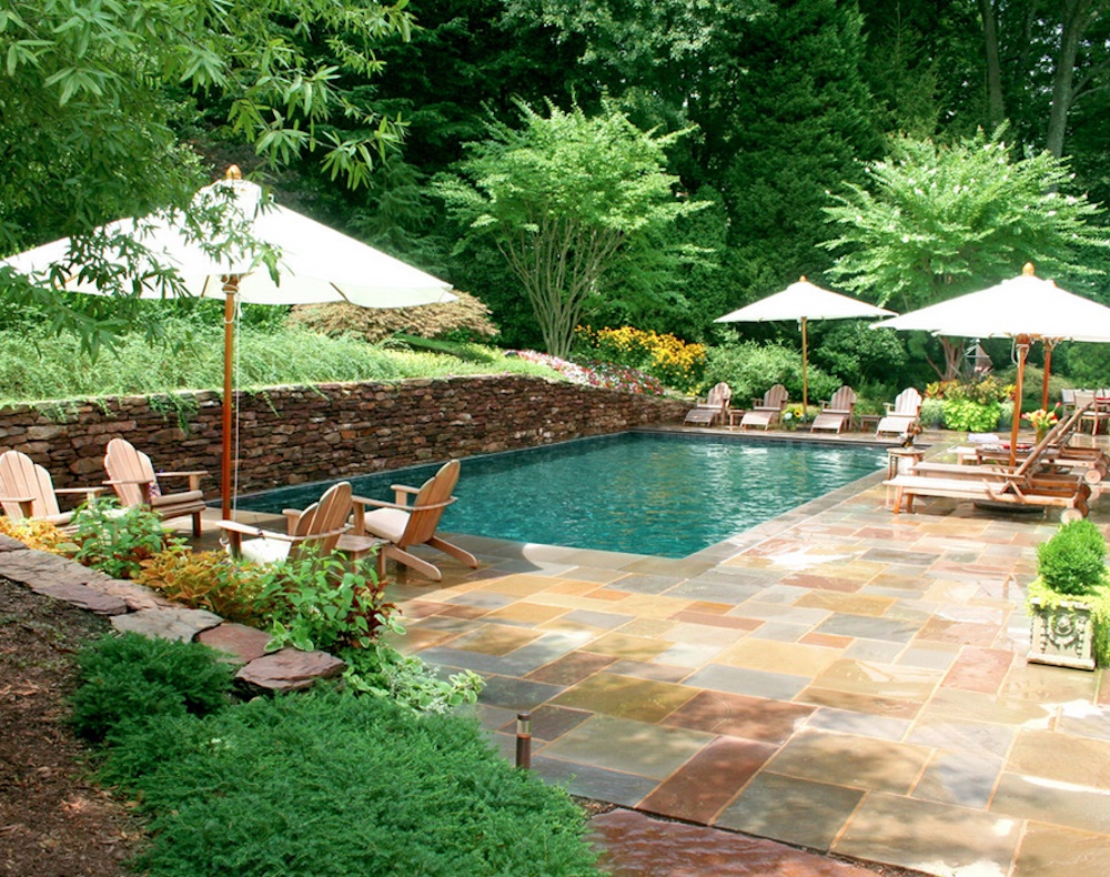 Backyard Landscape Vegetations Naturally Backyard Landscape With Lush Vegetation And Granite Tile Outdoor Flooring Decorated With Outdoor Wooden Chairs Swimming Pool Amazing Cool Swimming Pool Bringing Beautiful Exterior Style