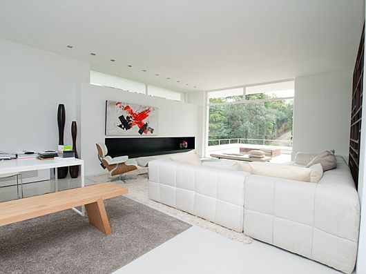 Cross Painting White Red Cross Painting Hanged On White Painted Concrete Walls Of Family Room In Sleek White Contemporary Villa In Madrid Apartments  Sophisticated Scandinavian Living Rooms As Inspirational Design For You