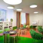 Green Accents Shagpile Refreshing Green Accents In Retro Shag Pile Chairs Child's Playroom And Homework Space Exaggerated Lighting On Glossy Floor Kids Room Cheerful Kid Playroom With Various Themes And Colorful Design