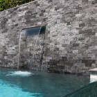 Vertical Waterfall Stone Relaxing Vertical Waterfall Installed On Stone Tiled Wall In Dream Backyard Home Swimming Pool With Infinity Concept Swimming Pool Beautiful Pool Backyard For Luxury And Fresh Backyard Look