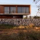 Stone Garden Modern Rustic Stone Garden Wall Surrounding Modern Architectural W House With Transparent Glass Wall Small Balcony With Dark Metallic Railing Architecture Elegant Concrete Home With Spacious And Modern Style In Thailand