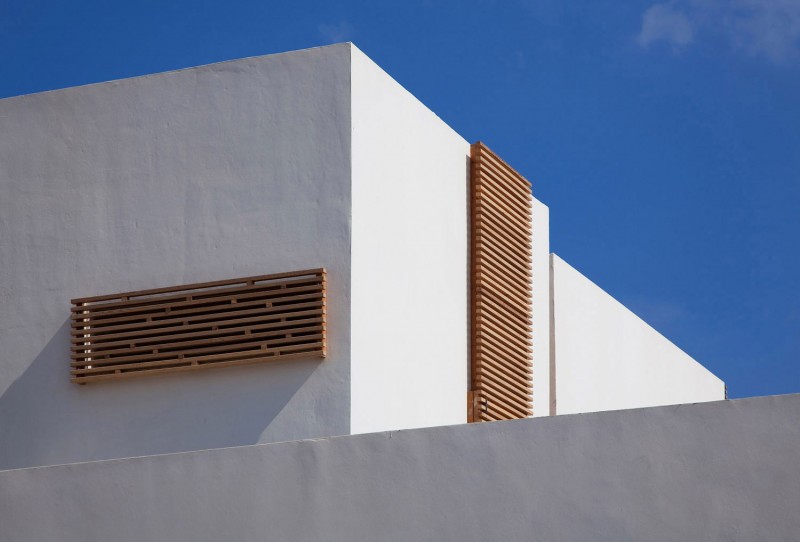 White Painted On Simple White Painted Wall Installed On The Artistic Clutter House Furnished With Unique Wooden Striped Perforated Windows Decoration  Surprising Home Decoration With An Open Landscape Of Seaside Views