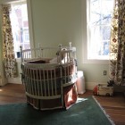 White Painted With Traditional White Painted Round Crib With Maroon Skirt Contrasted By Floral Patterned Curtain On Windows Kids Room Adorable Round Crib Decorated By Vintage Ornaments In Small Room