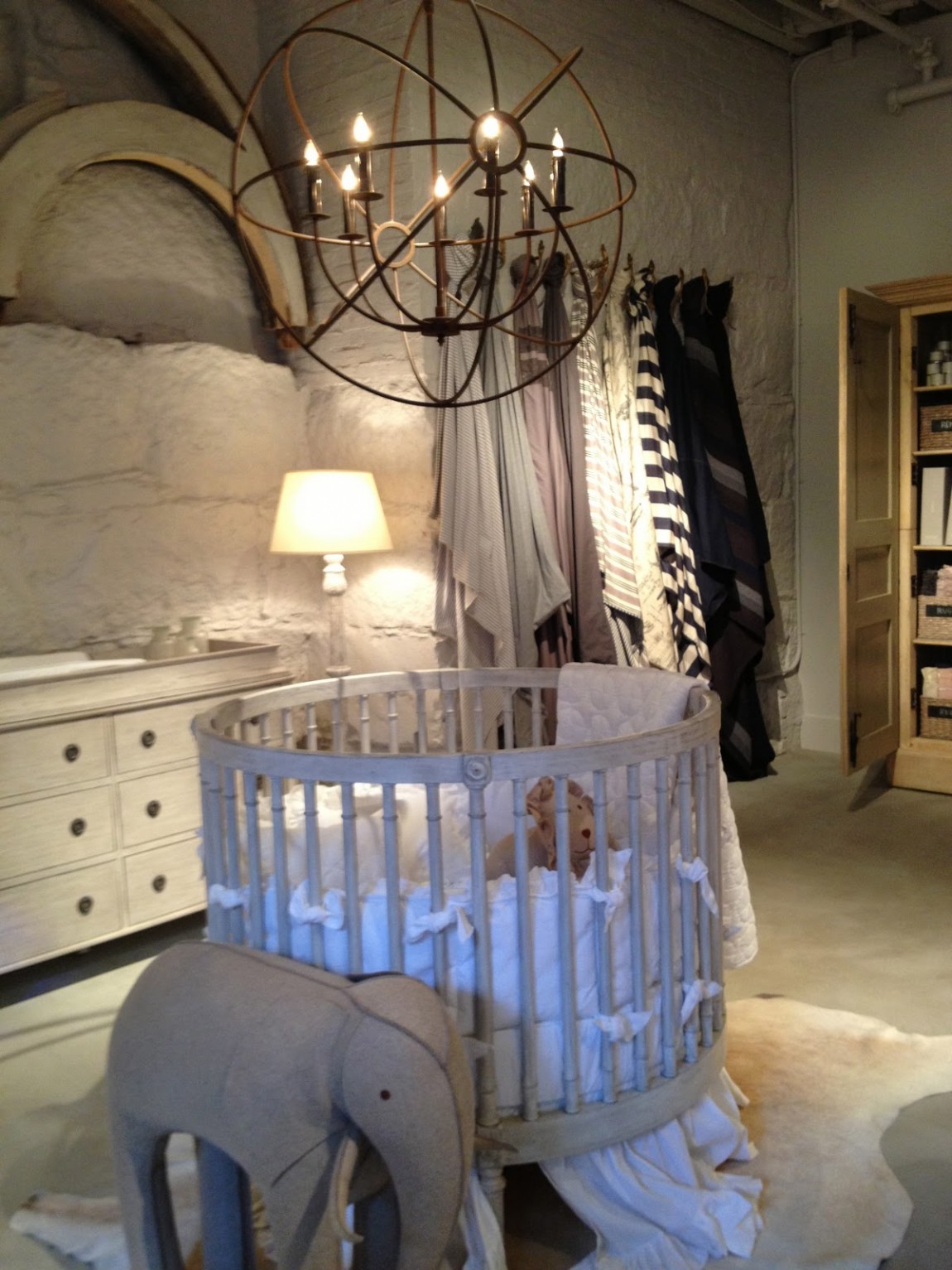 Home Baby With Warm Home Baby Room Designed With Unique Textured Grey Wall Hit By White Skirted Round Crib With Chandelier Decoration  Adorable Round Crib Decorated By Vintage Ornaments In Small Room