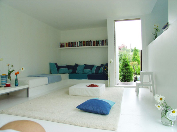 Living Room Kolonihagen Wonderful Living Room In Casa Kolonihagen Norway With Blue Throw Pillows And White Bookshelf Under White Ceiling Decoration Stunning Holiday House Design As Best Choice For Spending Summer Holiday