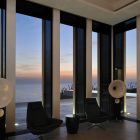 Beach And Sparkling Attractive Beach And Sunset View Sparkling Outdoor Lights Transparent Glass Wall Dark Glove Chairs Sleek Dark Stool Fidar Beach House Dream Homes Futuristic Modern Beach House With Neutral Color Palettes For A Family Of Five