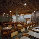 Pio Pio Sebastian Attractive Pio Pio Restaurant By Sebastian Marsical Studio With Many Small Short Candle On Wooden Dining Table With Wood Chairs Restaurant Stunning Wood Restaurant With Minimalist Decoration Approach