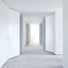 Corridor In L Awesome Corridor In The Villa L With White Doors And Grey Floor Under The White Ceiling Dream Homes Stunning Duplex Modern House Surrounded By Green Tree And Lawn Made From Concrete Material